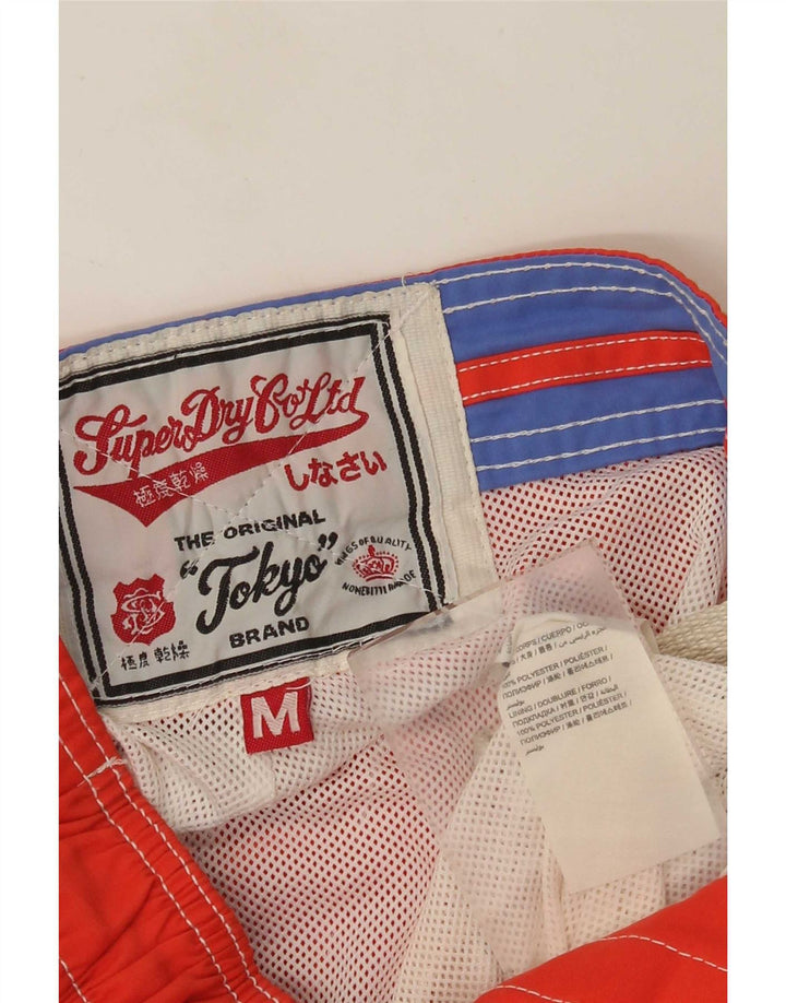 Superdry Herren-Badeshorts mit Grafik, mittelorangefarbenes Farbblock-Polyester