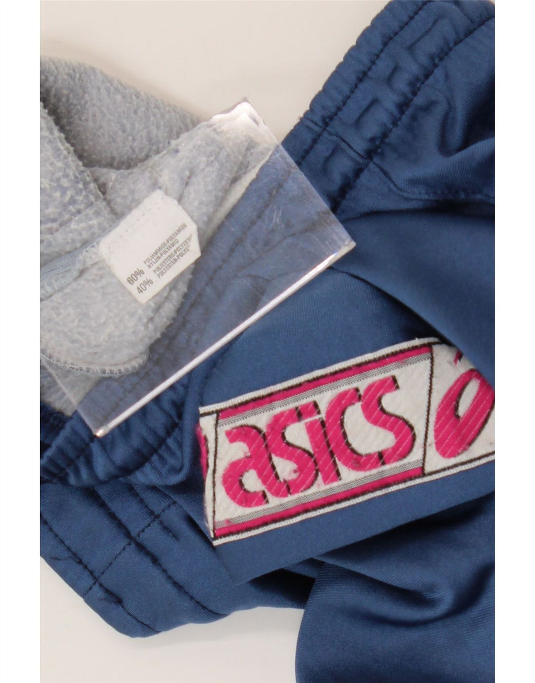 Asics Herren-Trainingshose mit Grafik, mittelblaues Colourblock-Polyamid