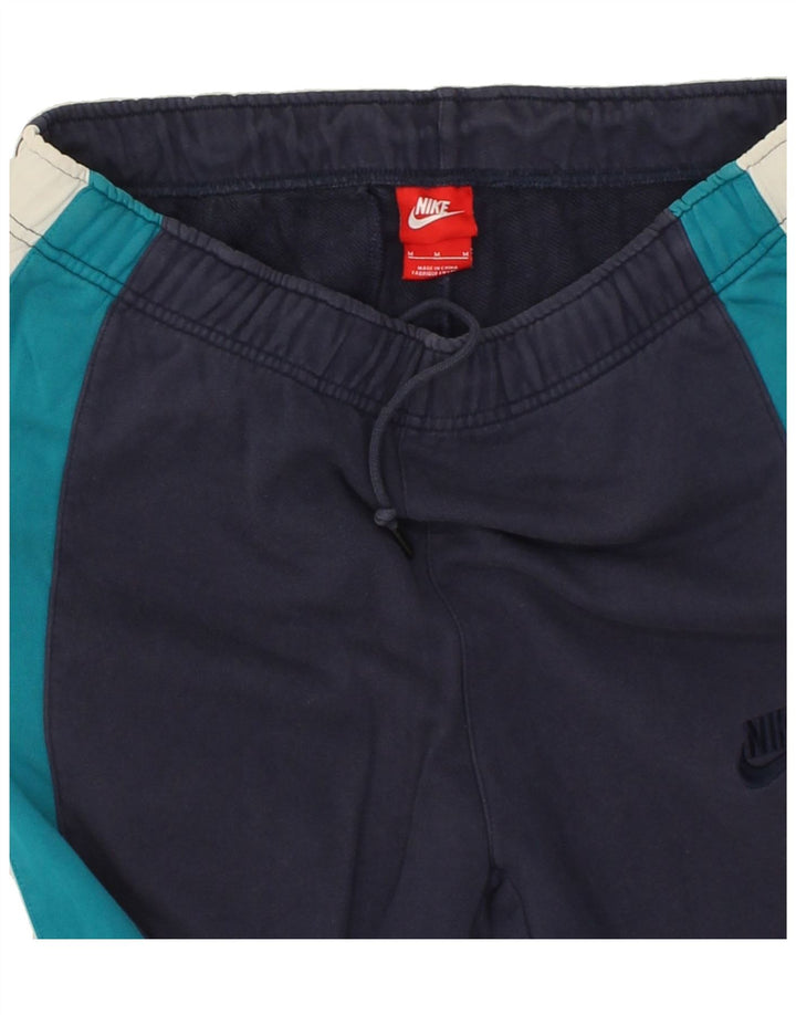 NIKE Mens Tracksuit Trousers Medium Navy Blue Colourblock Cotton Vintage Nike and Second-Hand Nike from Messina Hembry 